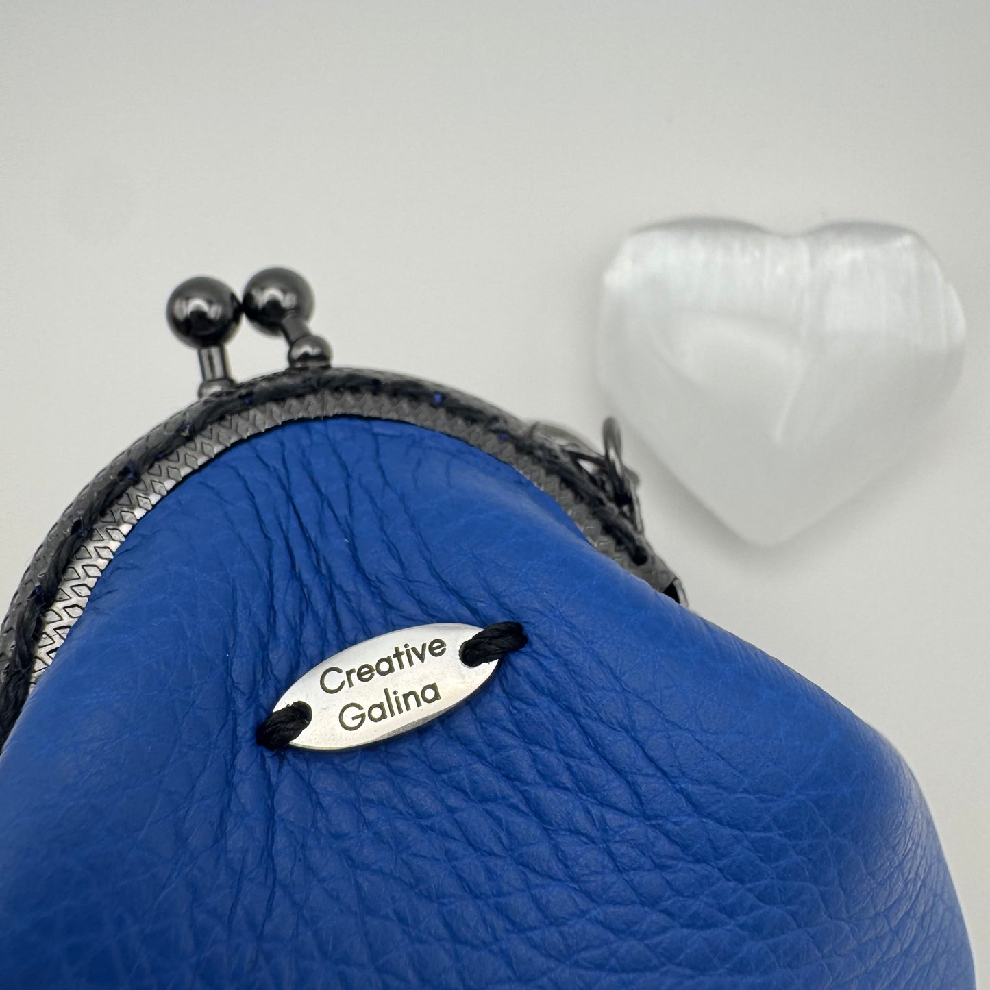 Protective eye leather pouch in Blue with Heart Selenite crystal.