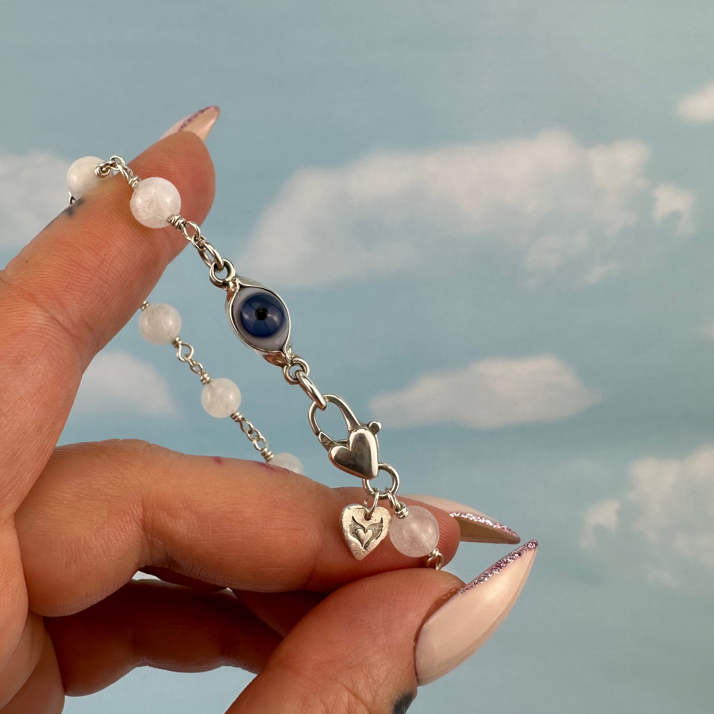 Protective eye with moonstone bracelet.