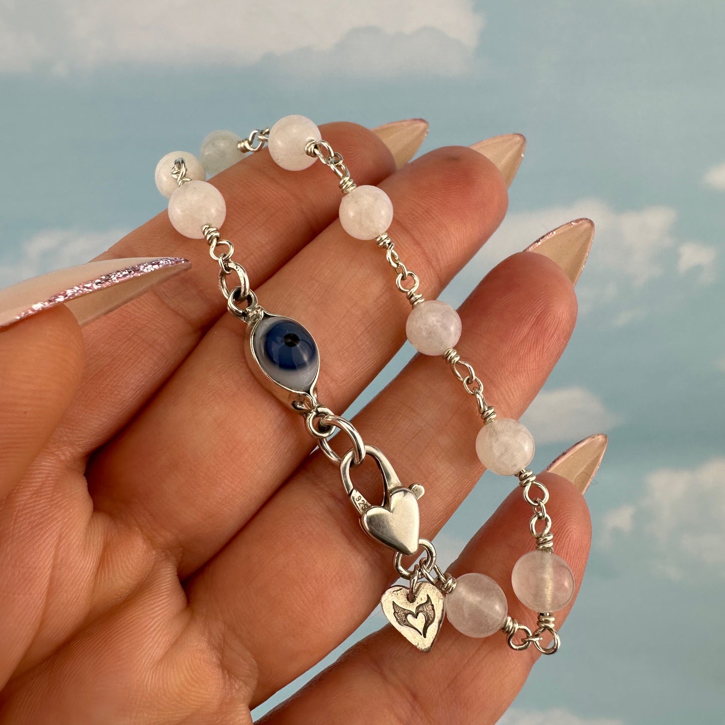 Protective eye with moonstone bracelet.